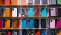 Different mobile phone cases on shelves in a multimedia store Royalty Free Stock Photo
