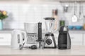 Different modern kitchen appliances on table indoors. Royalty Free Stock Photo