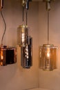 Different modern streamlined mirror copper chandeliers. Cylindrical metal copper shade pendant Royalty Free Stock Photo