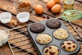 Different Muffins in bakeware or muffin pan on broun wooden background. Basic muffin recipe. Homemade muffins for breakfast or des