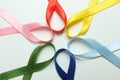 Different multi colored awareness ribbons on white background