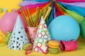 Different multicolored birthday accessories on yellow background