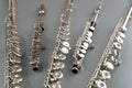 different musical instruments flute stacked on a gray surface