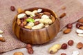 Different nuts: almonds, pistachios, peanuts, hazelnuts mix in wooden bowl on light background. Royalty Free Stock Photo