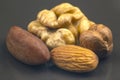 Different nuts close-up on a gray background. Healthy food and vitamins Royalty Free Stock Photo