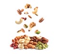 Different nuts falling into pile on background