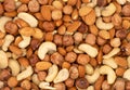 Different nuts in a heap texture background. Peanuts, almonds, hazelnuts and cashews mixed. Nuts pattern Royalty Free Stock Photo