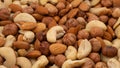 Different nuts in a heap texture background. Peanuts, almonds, hazelnuts and cashews mixed. Nuts pattern Royalty Free Stock Photo