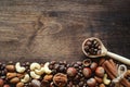 Different nuts on a wooden table. Cedar, cashew, hazelnut, walnu