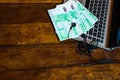 Different objects on wooden desk. Modern wooden office desk table with keyboard, documents and euro money