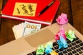 Different objects on wooden office desk. Modern wooden office desk table with laptop keyboard, office agenda, money and a colorful Royalty Free Stock Photo