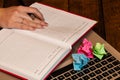 Different objects on wooden office desk. Modern wooden office desk table with laptop keyboard, crumpled paper, office agenda. Royalty Free Stock Photo