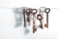 A different old retro rusty keys from different locks hanging on string Royalty Free Stock Photo