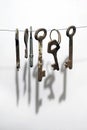 A different old retro rusty keys from different locks hanging on string Royalty Free Stock Photo