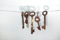 A different old retro rusty keys from different locks hanging on string Royalty Free Stock Photo