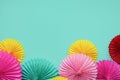 Different paper flowers on green background. Festive or party background. Flat lay style. Copy space for text. Birthday greeting c