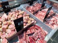 Different parts of meat pork display in supermarket. There is a price tag in Thai language. Cooled fresh meat and good cuisine