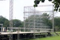 Different parts of metal scaffold on the construction field. Workers build a concert stage. Stage equipment Royalty Free Stock Photo