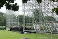 Different parts of metal scaffold on the construction field. Workers build a concert stage. Stage equipment Royalty Free Stock Photo