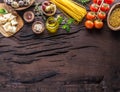 Different pasta types in wooden spoons on the table. Top view Royalty Free Stock Photo