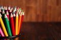 Different pencils on the brown wooden table background Royalty Free Stock Photo