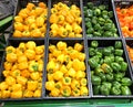 Different peppers yellow and green lying in boxes in a supermarket Royalty Free Stock Photo