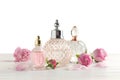 Different perfume bottles and flowers