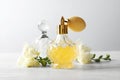 Different perfume bottles and flowers on background Royalty Free Stock Photo