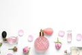 Different perfume bottles and flowers on white , top view Royalty Free Stock Photo