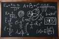 Different physical formulas written with chalk on blackboard Royalty Free Stock Photo