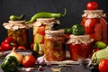 Different pickled vegetables in glass jars for long-term storage: salad with eggplant, peppers, cucumbers, tomatoes and mixed