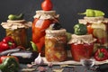 Different pickled vegetables in glass jars for long-term storage: salad with eggplant, peppers in tomato sauce, cucumbers,