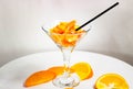 Different pieces of fresh orange fruit in a glass. Orange, tangerine, and persimmon. A healthy dessert with vitamin a Royalty Free Stock Photo