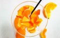 Different pieces of fresh orange fruit in a glass. Orange, tangerine, and persimmon. A healthy dessert with vitamin a Royalty Free Stock Photo