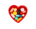 Different pills in box in shape of heart