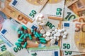 different pills on euro bills as background Royalty Free Stock Photo