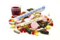 Different pills, medications with medicine with a syringe and with thermometer on white background closeup.
