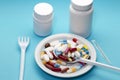 Different colorful pills on a plate with two bottle Royalty Free Stock Photo