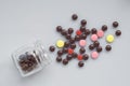 Different pills spill out of a glass jar on light surface Royalty Free Stock Photo