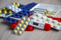 Tablets and thermometer on the table. Royalty Free Stock Photo