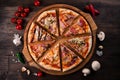 Different pizza slices on a round wooden Board Royalty Free Stock Photo