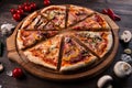 Different pizza slices on a round wooden Board Royalty Free Stock Photo