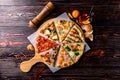 Different pizza slices on a wooden table mix Royalty Free Stock Photo