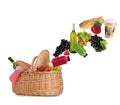 Different products falling in picnic basket on background Royalty Free Stock Photo