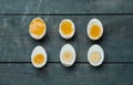 Different readiness stages of boiled chicken eggs on blue wooden table, flat lay Royalty Free Stock Photo