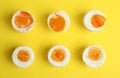 Different readiness stages of boiled chicken eggs on yellow background