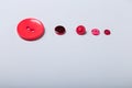 Different red buttons on white background arranged to size from big to small. Royalty Free Stock Photo