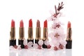 Different red lipstick and cherry flower Royalty Free Stock Photo