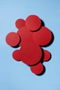 Different red textured circles soar as swarm shape on blue background, decorative space for text, colorful abstract backdrop.