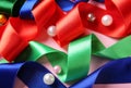 Different ribbons with beads on color background Royalty Free Stock Photo